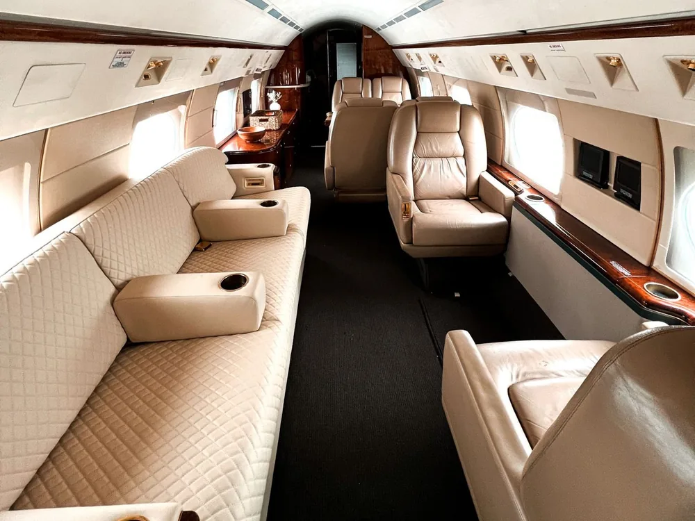 Cream leather seats and wood trim inside a private aircraft