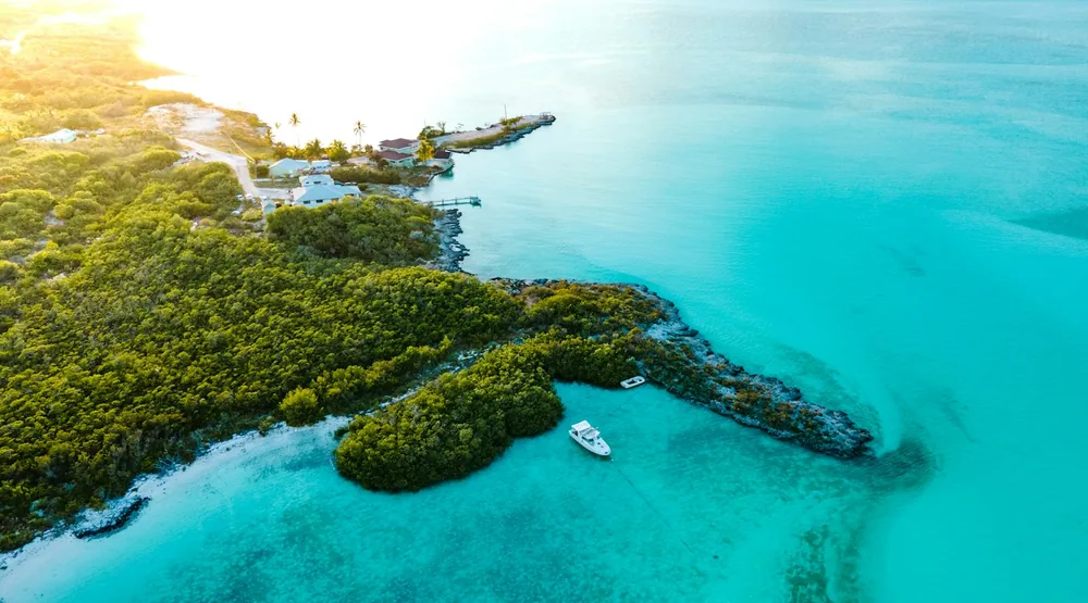 Turquoise water and rocky shoreline in Exuma, The Bahamas — illustrative journey photograph