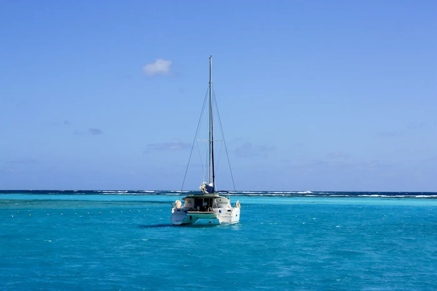 Sailing catamaran on turquoise water